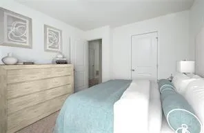 a bedroom with a bed and lamp