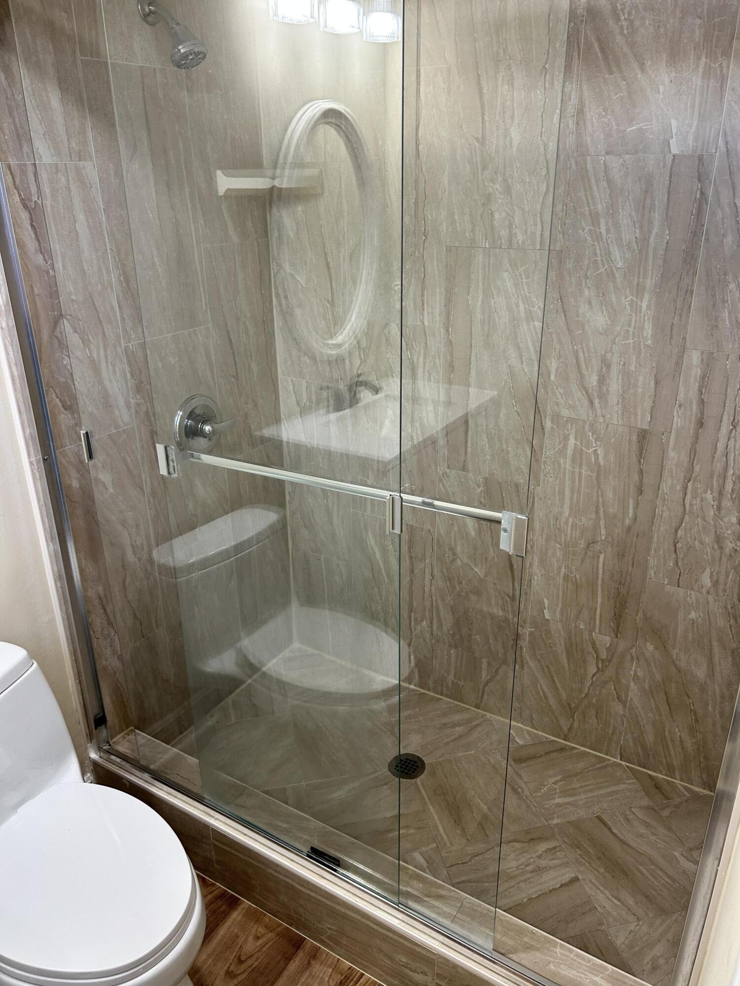 5201 Northwest 2nd Avenue, Unit 112 Boca Raton, FL 33487 - Photo 21 of 40 a bathroom with a shower and toilet