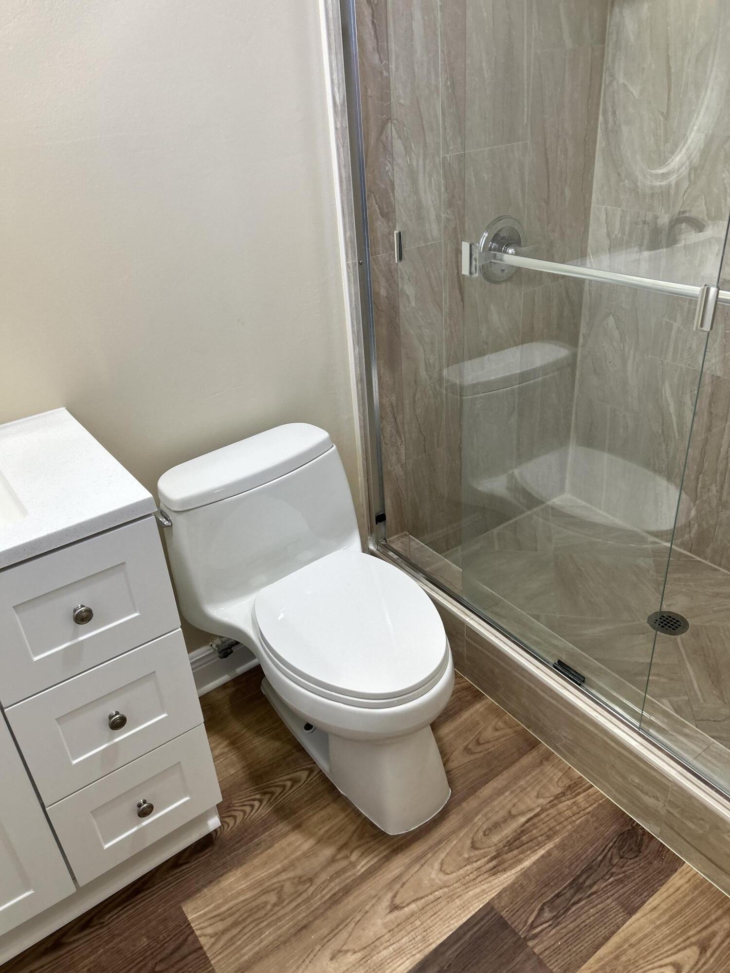 5201 Northwest 2nd Avenue, Unit 112 Boca Raton, FL 33487 - Photo 22 of 40 a bathroom with a toilet and a shower