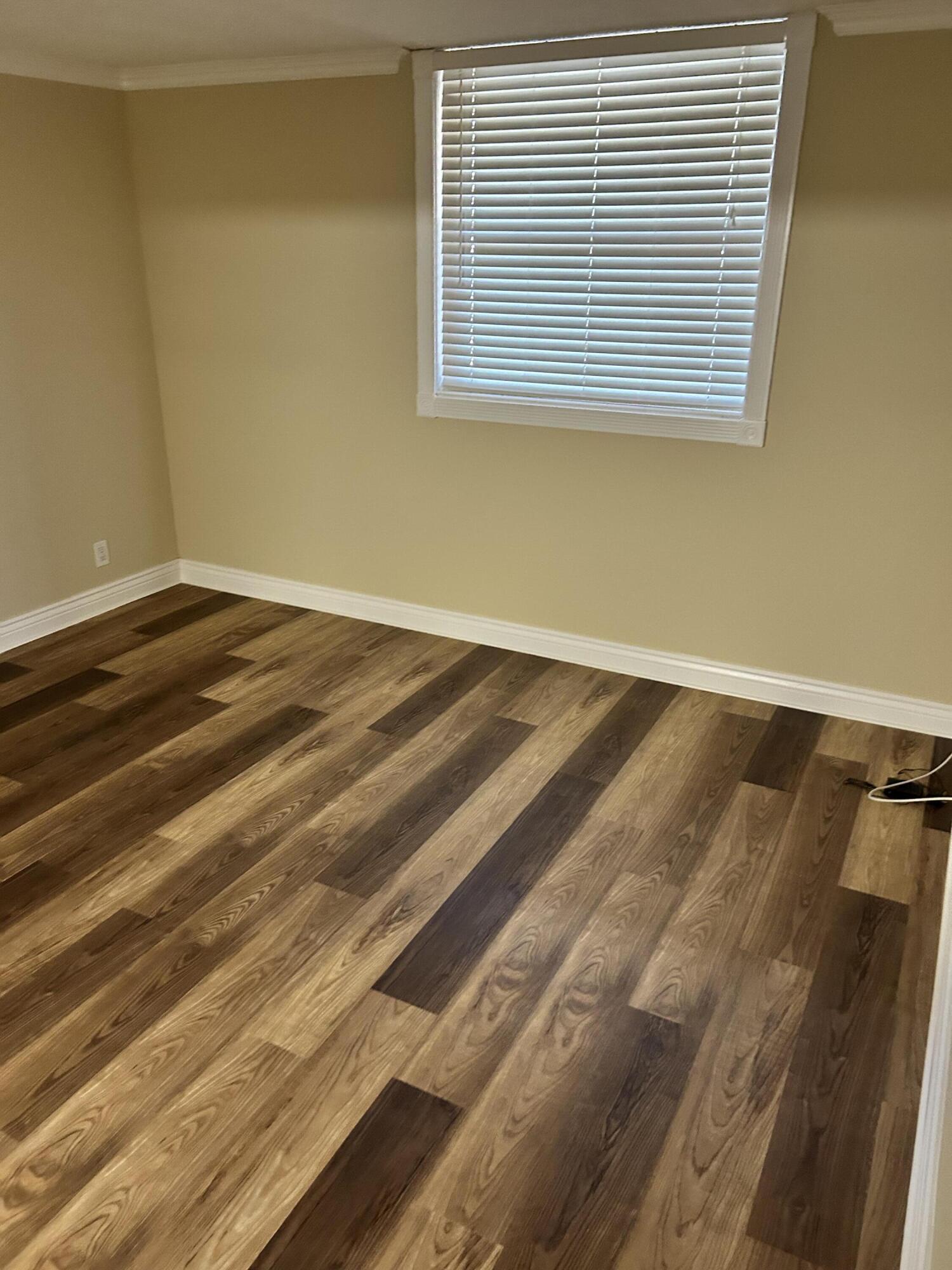 5201 Northwest 2nd Avenue, Unit 112 Boca Raton, FL 33487 - Photo 25 of 40 a view of a room with wooden floor and a window