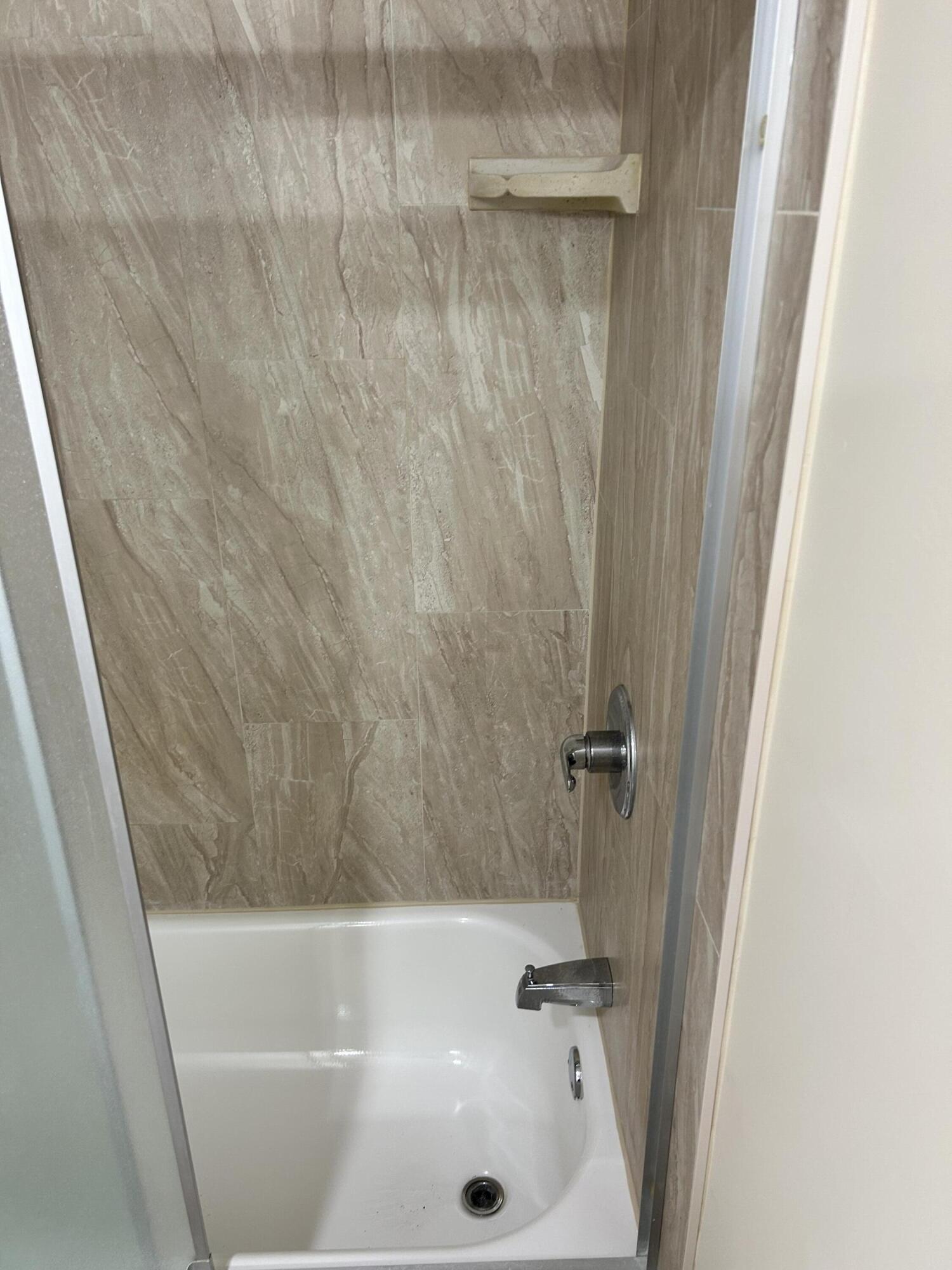 5201 Northwest 2nd Avenue, Unit 112 Boca Raton, FL 33487 - Photo 33 of 40 a bathroom with a bathtub