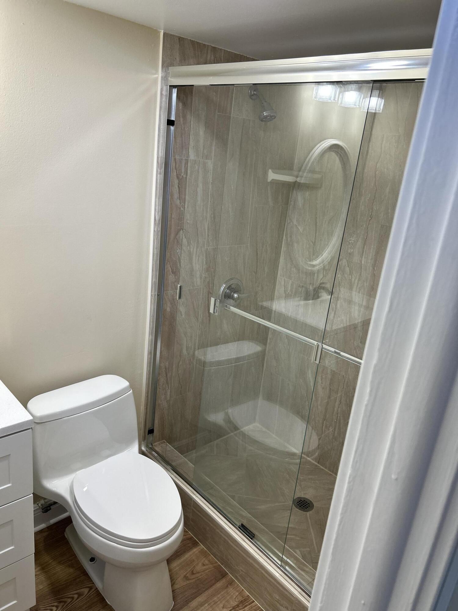 5201 Northwest 2nd Avenue, Unit 112 Boca Raton, FL 33487 - Photo 38 of 40 a bathroom with a shower and toilet
