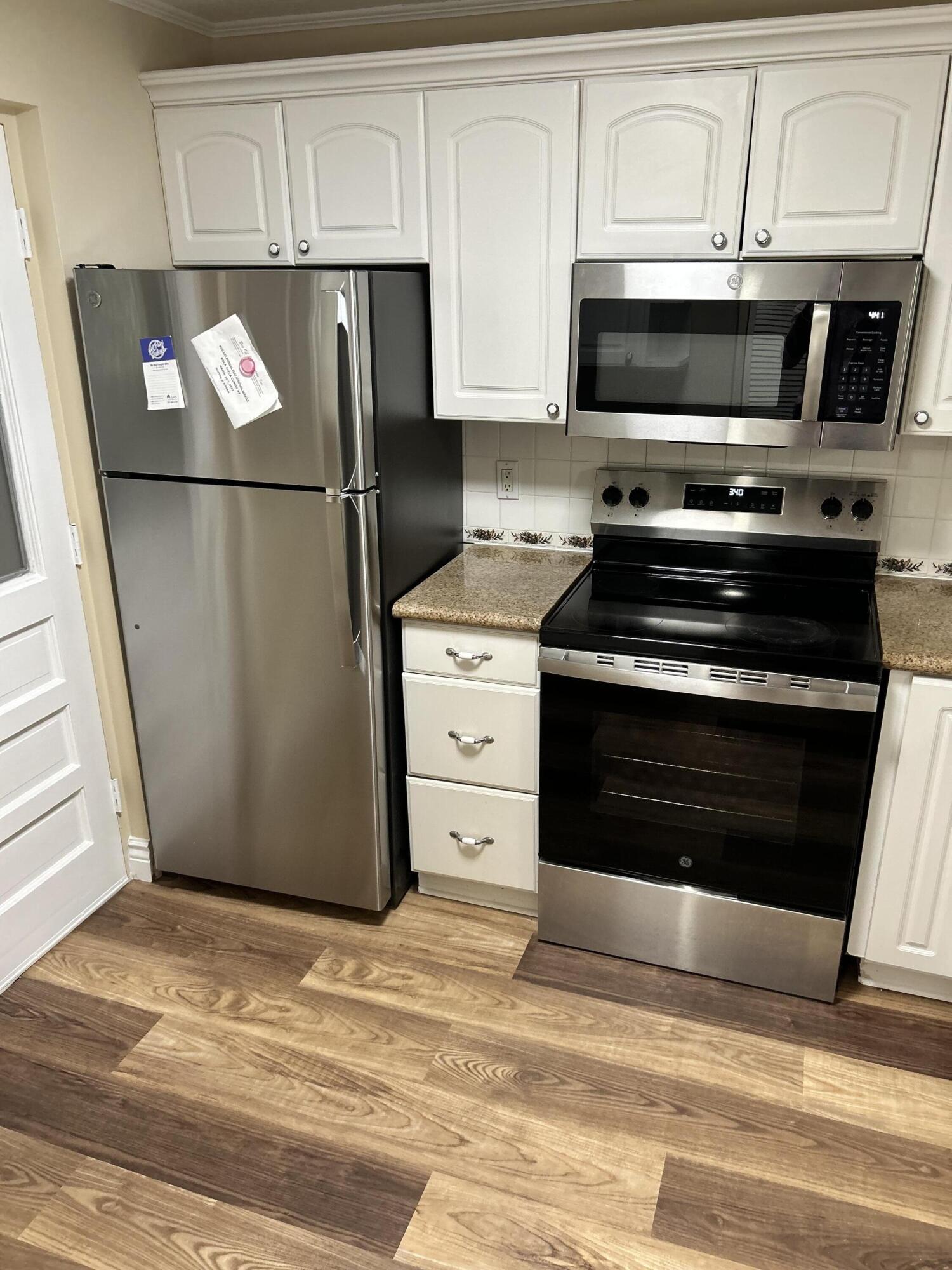 5201 Northwest 2nd Avenue, Unit 112 Boca Raton, FL 33487 - Photo 5 of 40 a kitchen with stainless steel appliances granite countertop a refrigerator stove and microwave