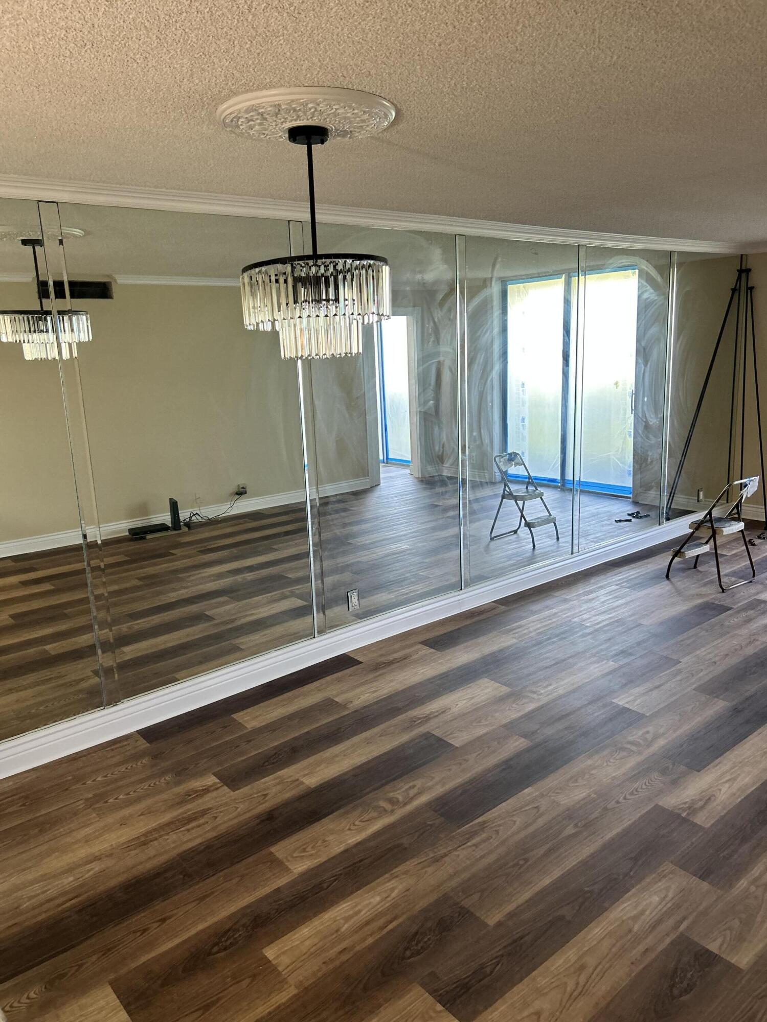 5201 Northwest 2nd Avenue, Unit 112 Boca Raton, FL 33487 - Photo 8 of 40 a view of a room with wooden floor gym equipment and windows