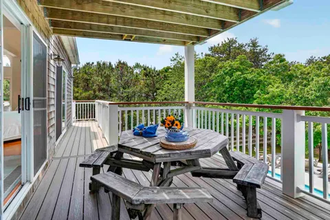 a kitchen with stainless steel appliances a kitchen island hardwood floor sink stove dining table and chairs