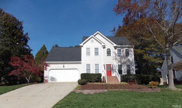 a view of house with yard and green space