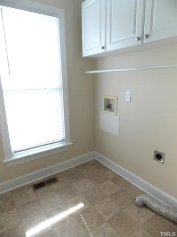 a view of a closet area with white paint cabinets