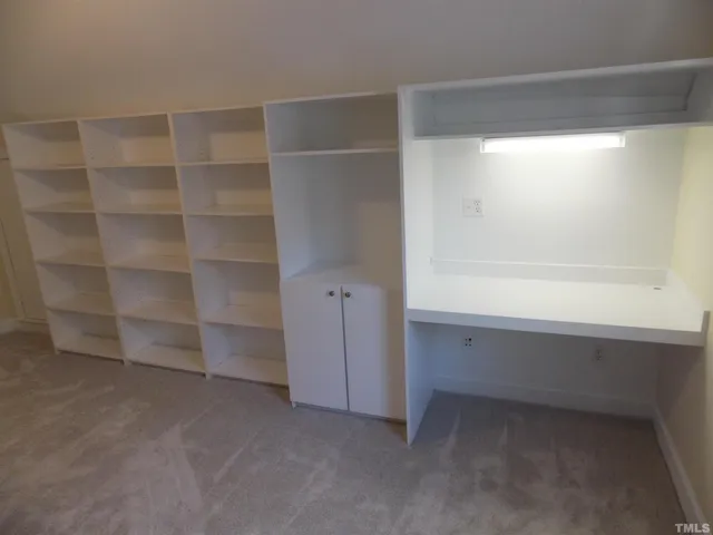 a view of an empty room with empty shelves