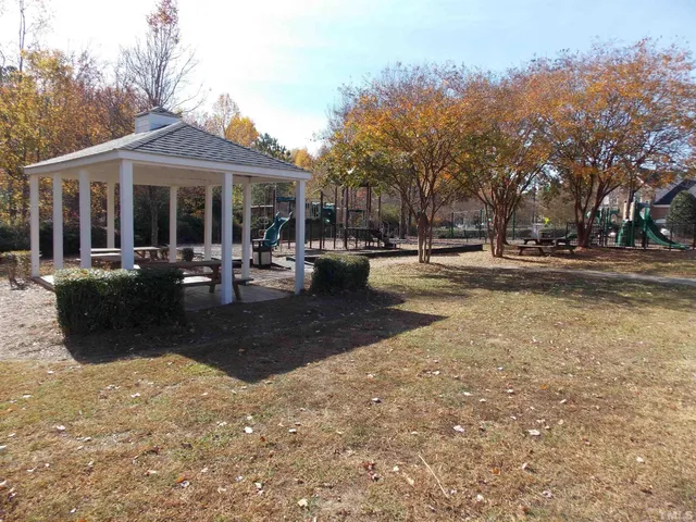 a view of a house with swimming pool and sitting area