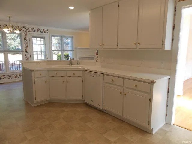 a view of a kitchen with sink and cabinets