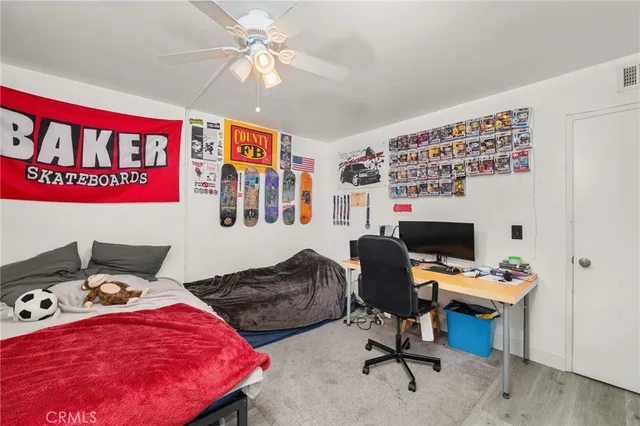 a spacious bathroom with a granite countertop sink a toilet a mirror and shower curtain