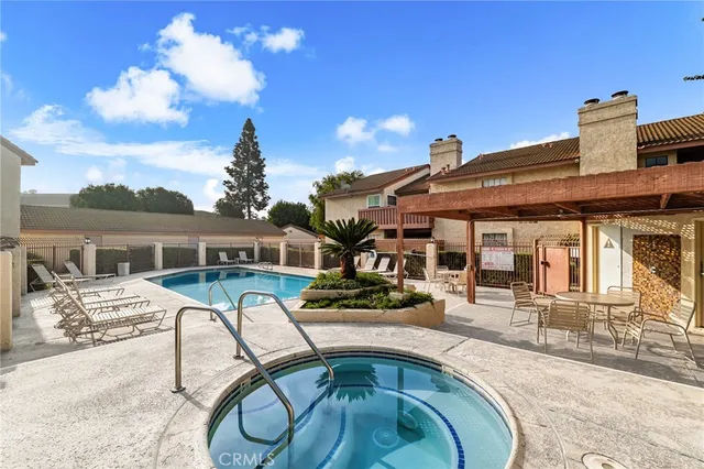 a view of a fountain in front of a house with a big yard