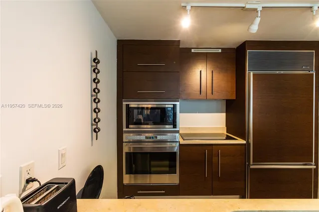a kitchen with a refrigerator and a sink