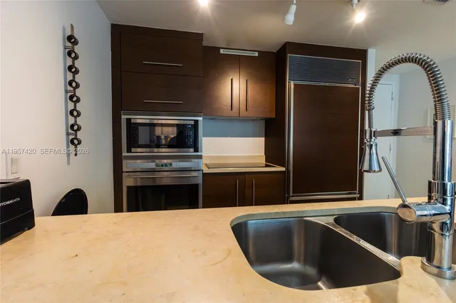 a kitchen with a refrigerator and a sink