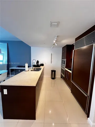 a refrigerator freezer sitting inside of a kitchen