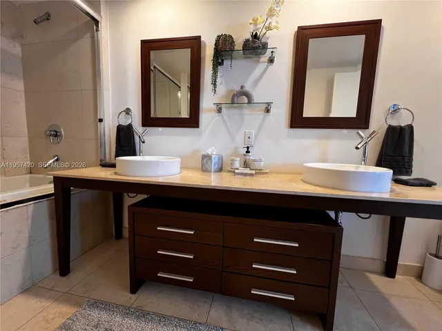 a bathroom with a tub and shower