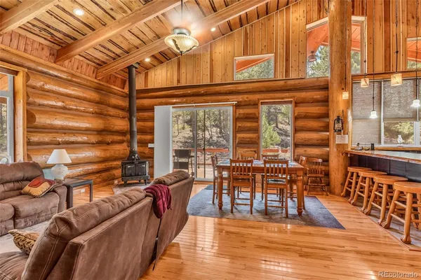 a dining room with furniture window and wooden floor
