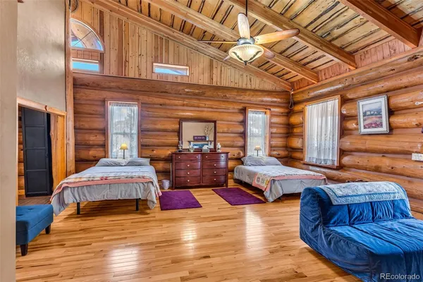 a bedroom with furniture and wooden floor