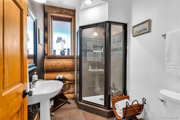 a bathroom with a sink mirror toilet and shower
