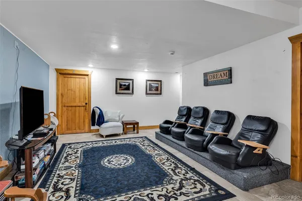 a living room with furniture rug and a flat screen tv