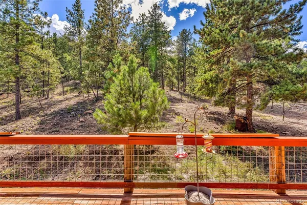 a view of a blue house with a yard