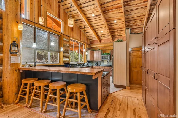 a view of a kitchen with a sink and wooden cabinets