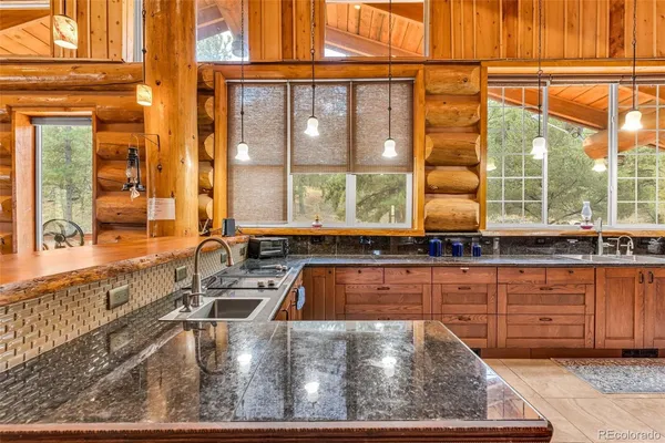 a kitchen with a sink and a large window