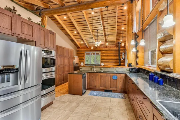 a kitchen with stainless steel appliances granite countertop a sink and cabinets