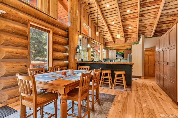 a dining room with furniture and wooden floor
