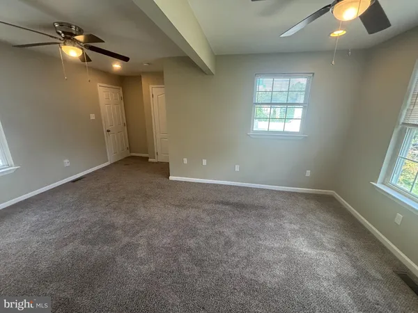 an empty room with a empty space and windows