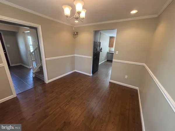 wooden floor in an empty room with a mirror