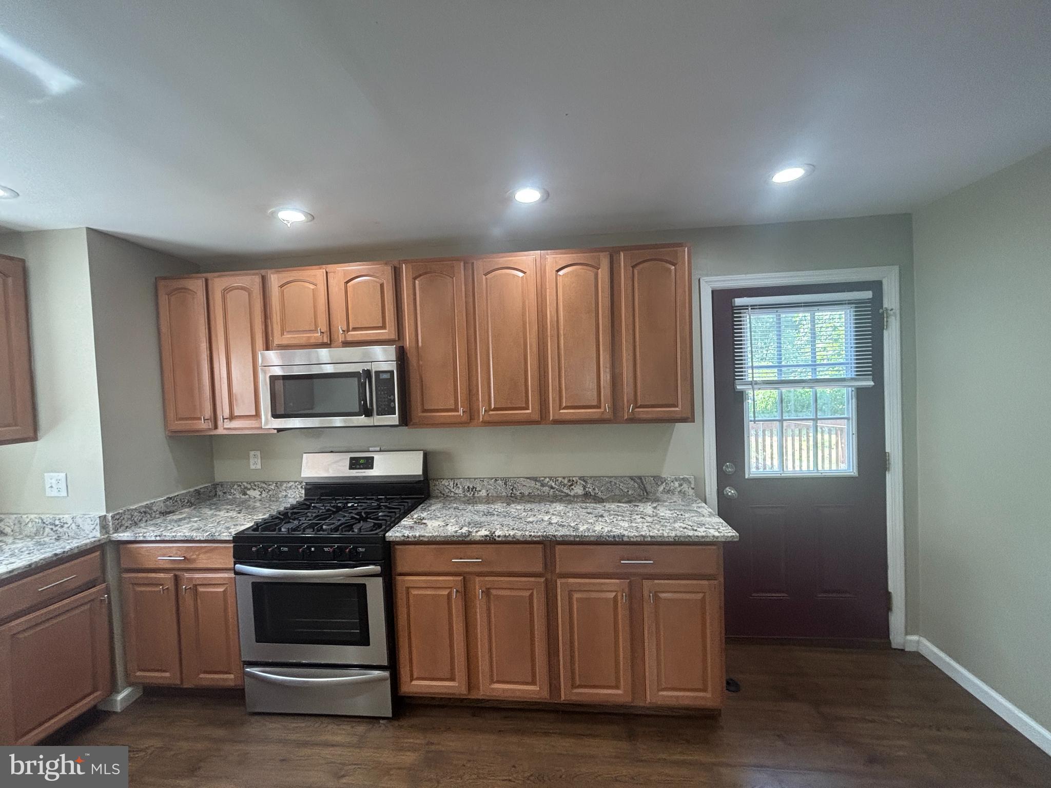 3 Balsley Court Sicklerville, NJ 08081 - Photo 5 of 24 a kitchen with granite countertop kitchen island stainless steel appliances a stove sink and microwave