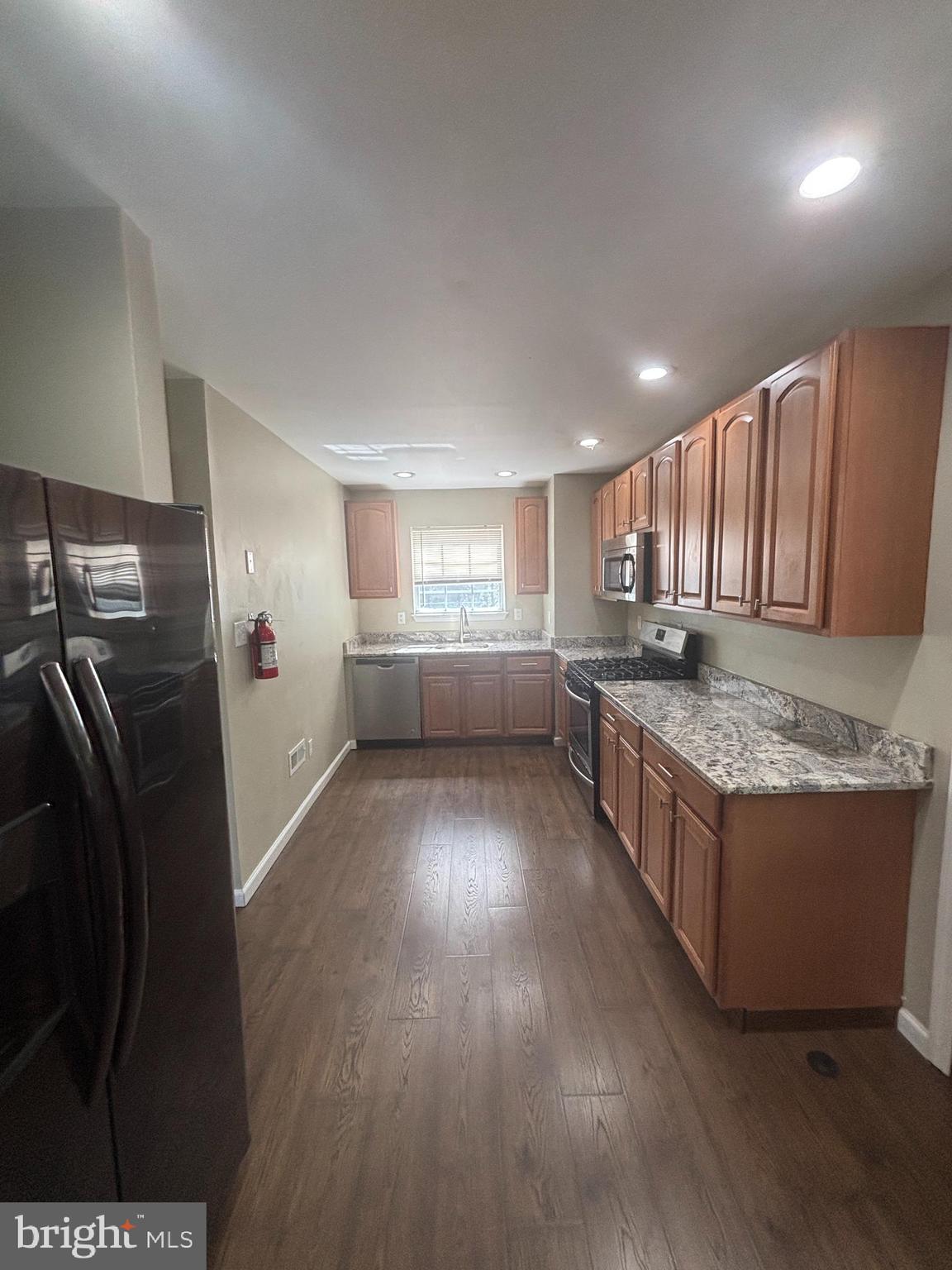3 Balsley Court Sicklerville, NJ 08081 - Photo 6 of 24 a kitchen with granite countertop a refrigerator and a stove top oven