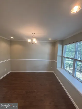 an empty room with an empty space and windows