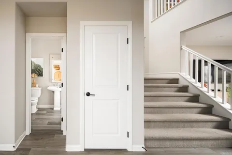 a view of a hallway with wooden floor and entryway