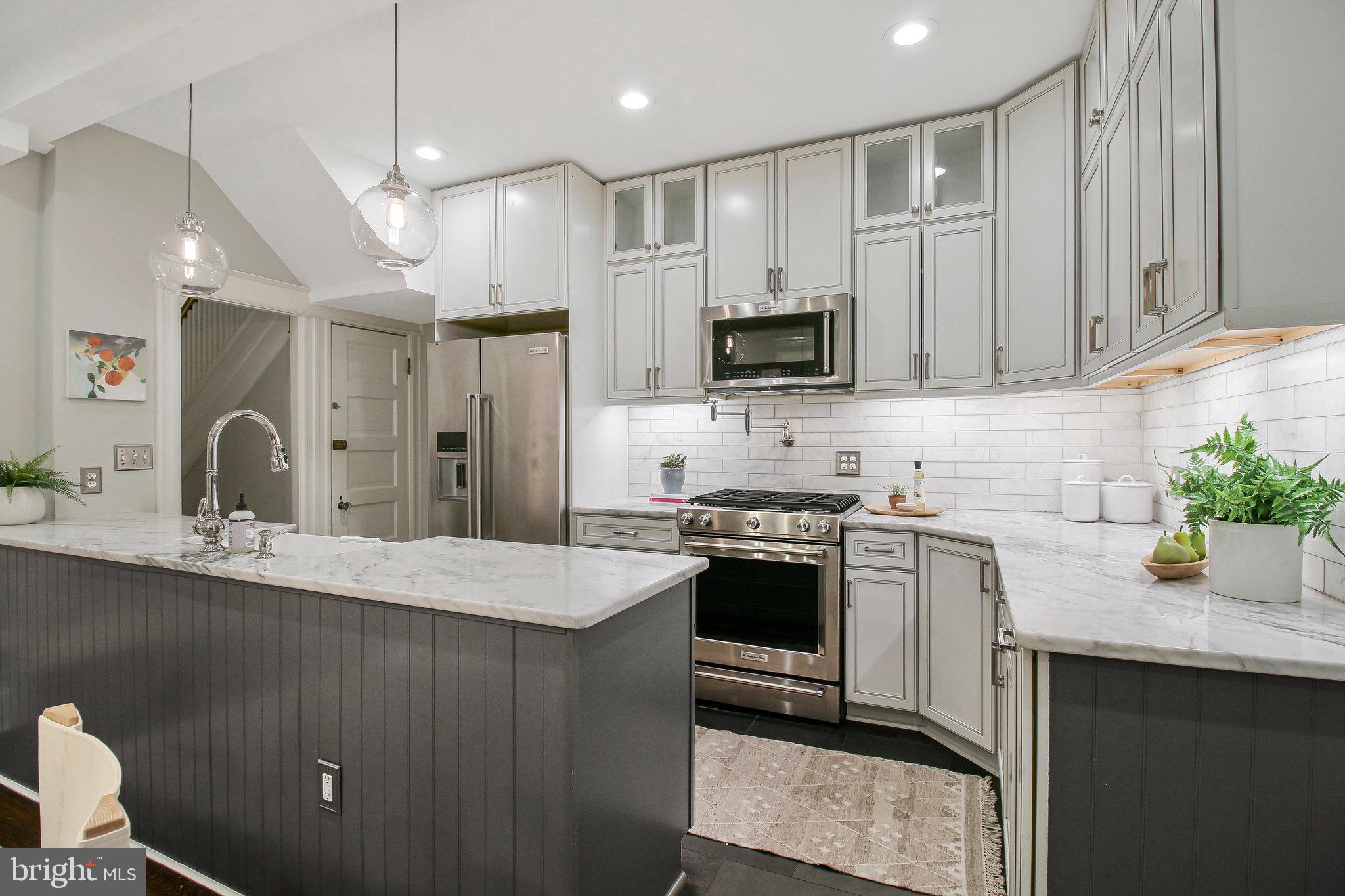 239 11th Street Southeast Washington, DC 20003 - Photo 12 of 53 a kitchen with stainless steel appliances granite countertop a sink stove and refrigerator