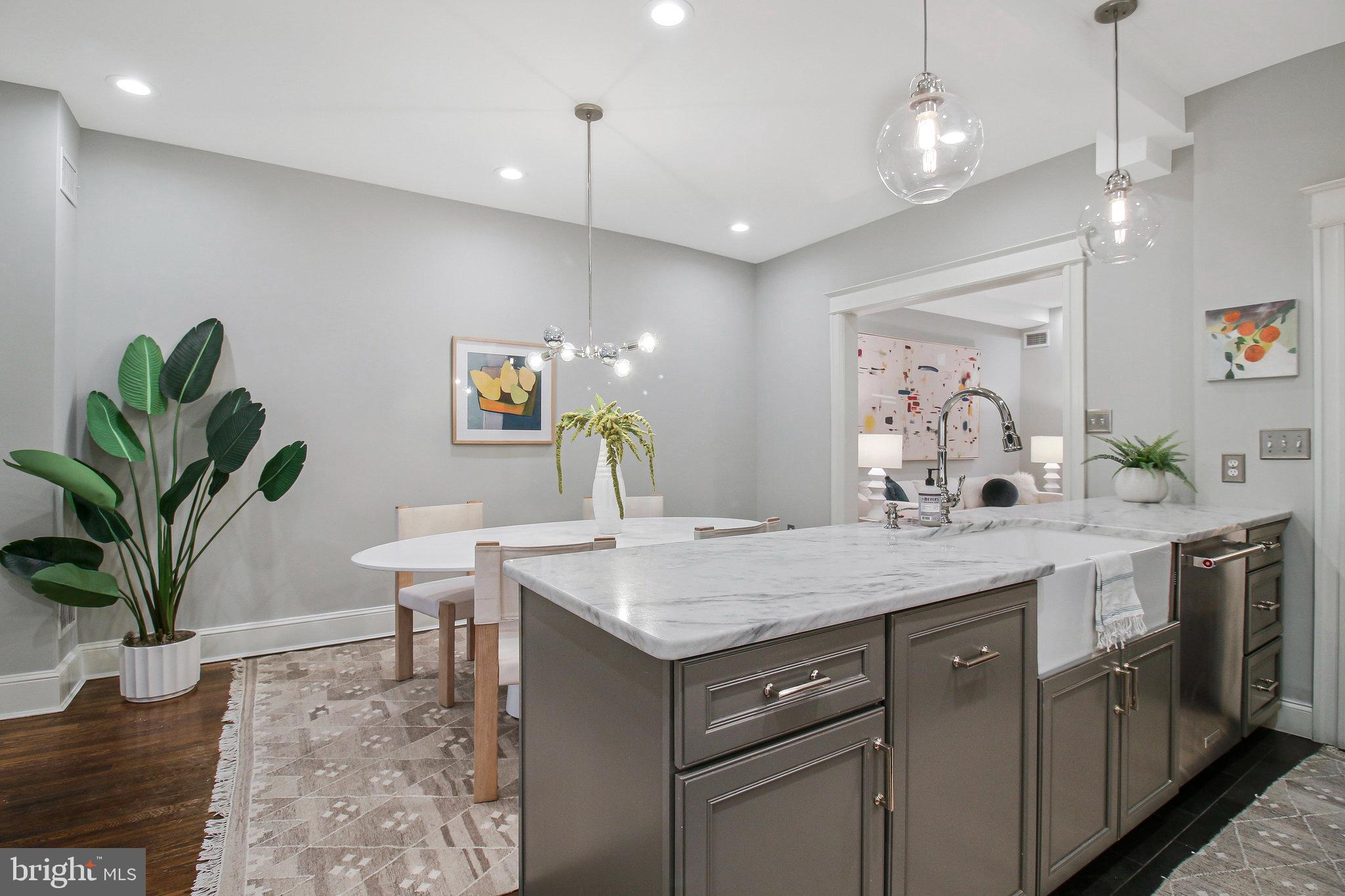 239 11th Street Southeast Washington, DC 20003 - Photo 13 of 53 a kitchen with a table a sink and cabinets