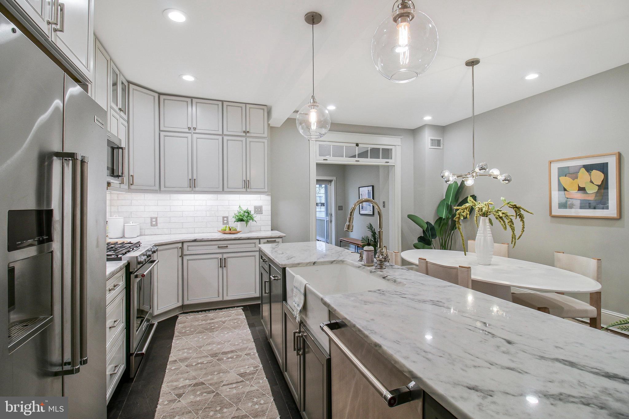 239 11th Street Southeast Washington, DC 20003 - Photo 14 of 53 a kitchen with a sink refrigerator and microwave