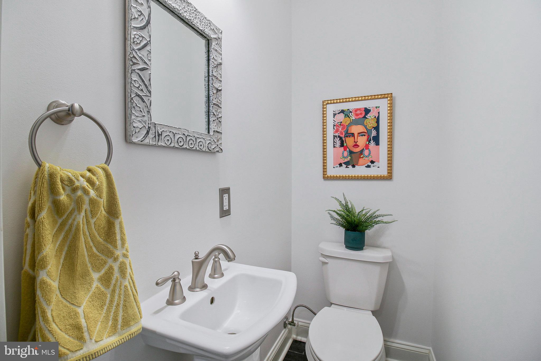 239 11th Street Southeast Washington, DC 20003 - Photo 18 of 53 a bathroom with a toilet sink and mirror