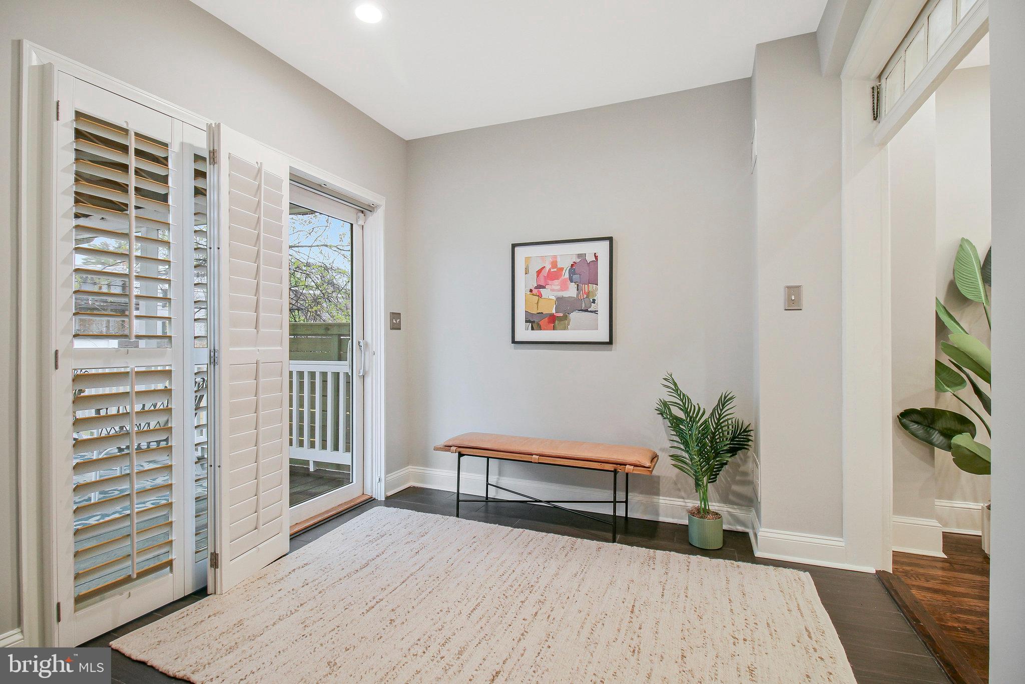 239 11th Street Southeast Washington, DC 20003 - Photo 20 of 53 a spacious bedroom with a bed and a potted plant