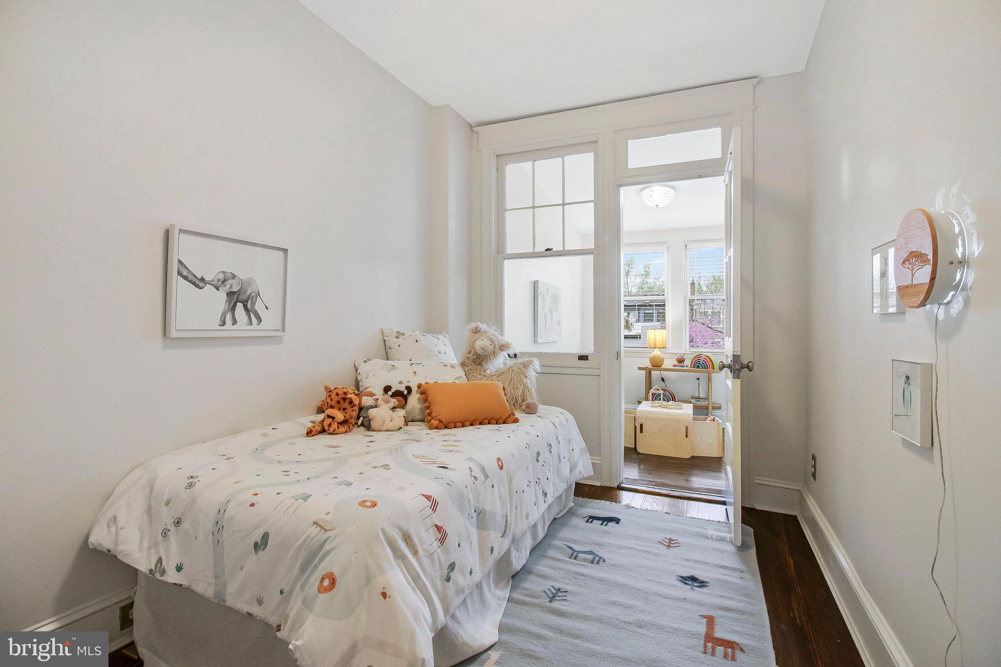 239 11th Street Southeast Washington, DC 20003 - Photo 28 of 53 a bedroom with 2 bed and a large window