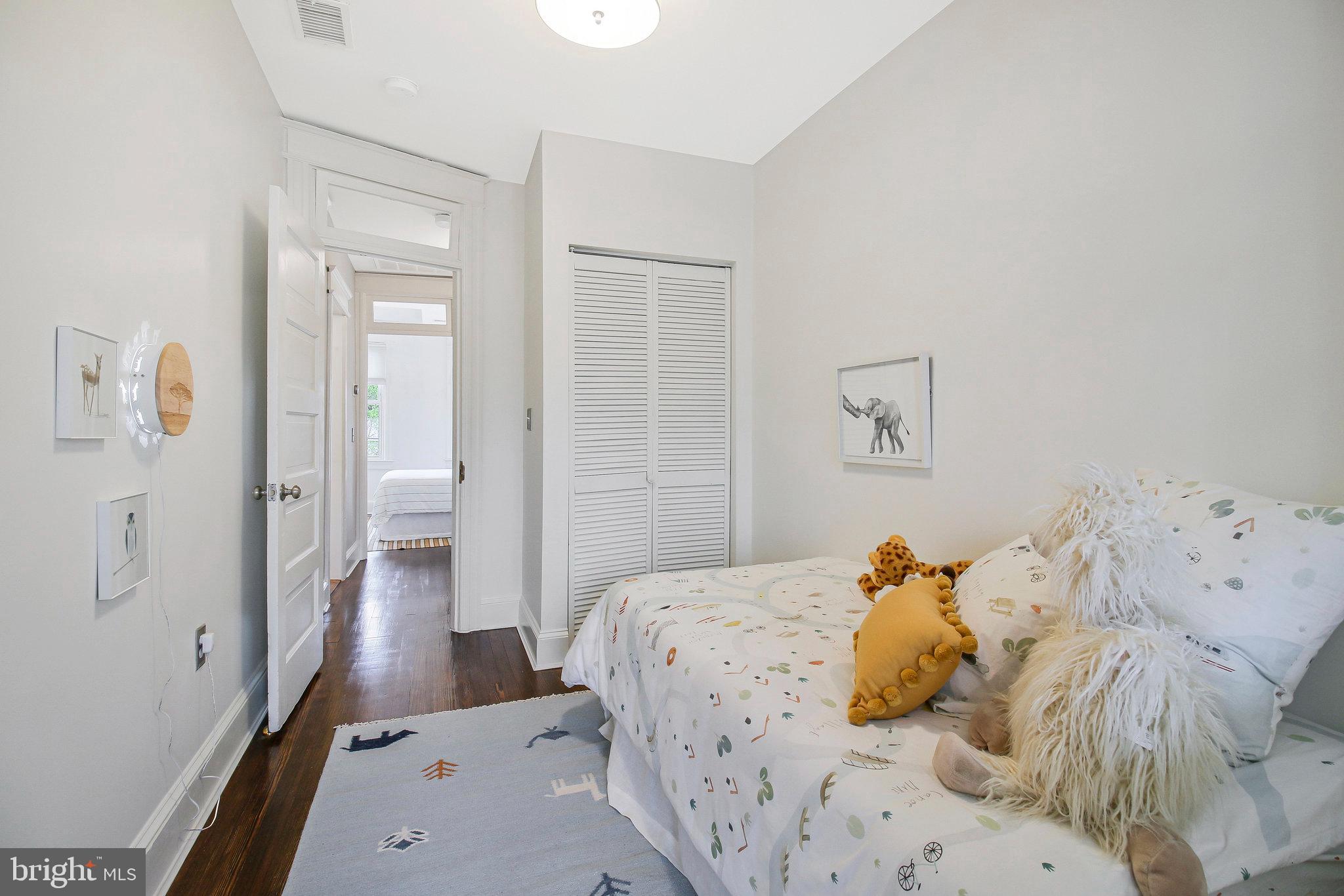 239 11th Street Southeast Washington, DC 20003 - Photo 29 of 53 a bedroom with a bed and wooden floor