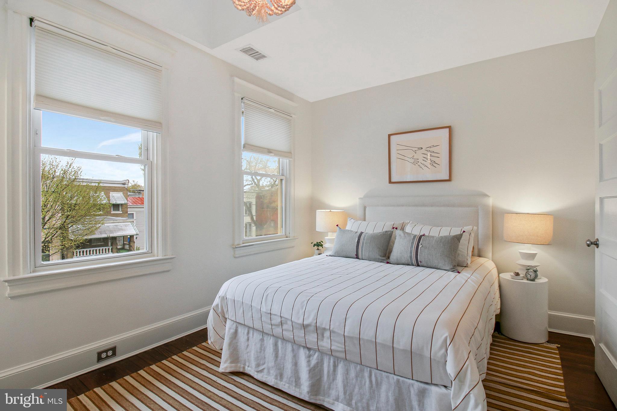 239 11th Street Southeast Washington, DC 20003 - Photo 39 of 53 a bedroom with a bed and a window