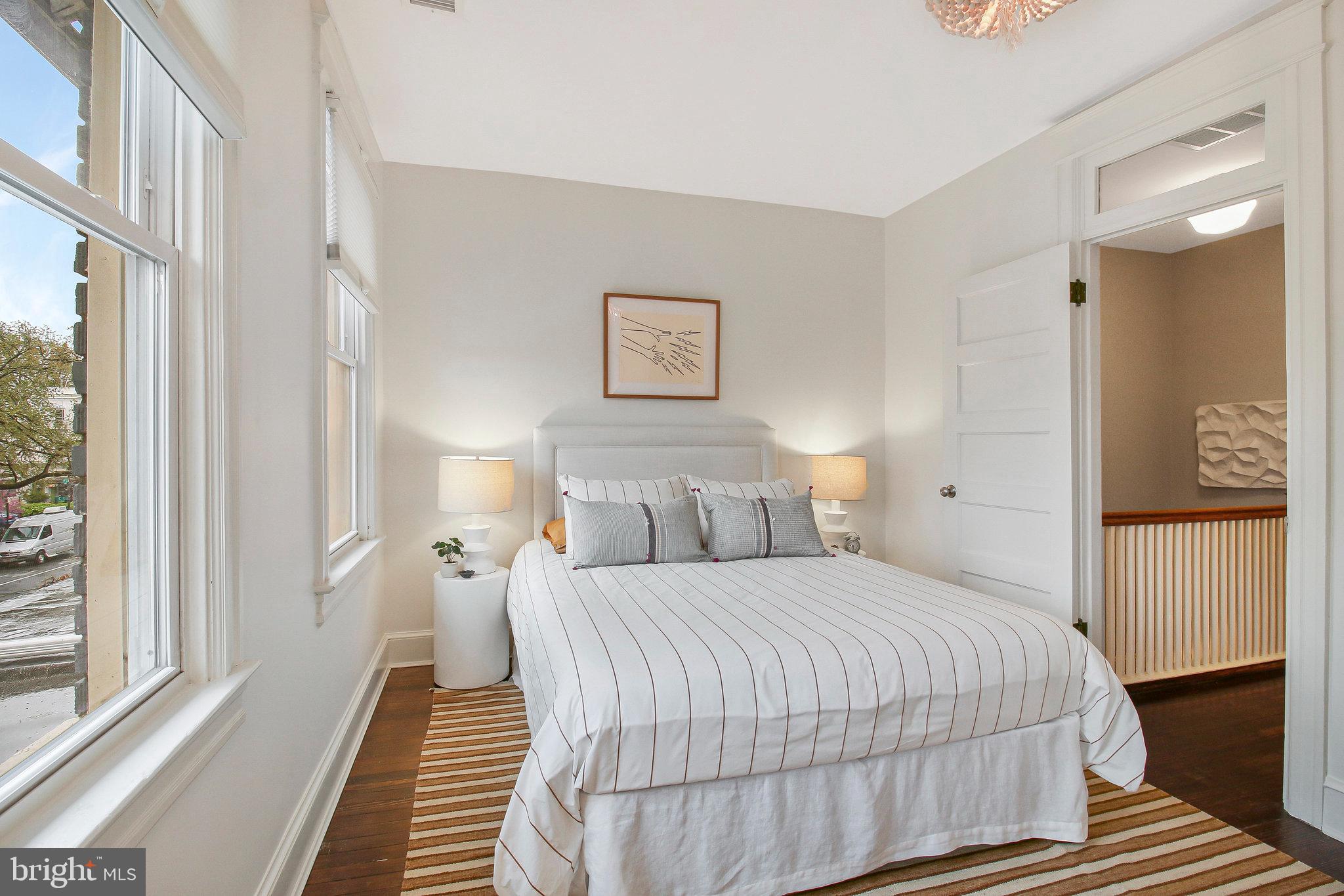 239 11th Street Southeast Washington, DC 20003 - Photo 41 of 53 a bedroom with a bed and wooden floor