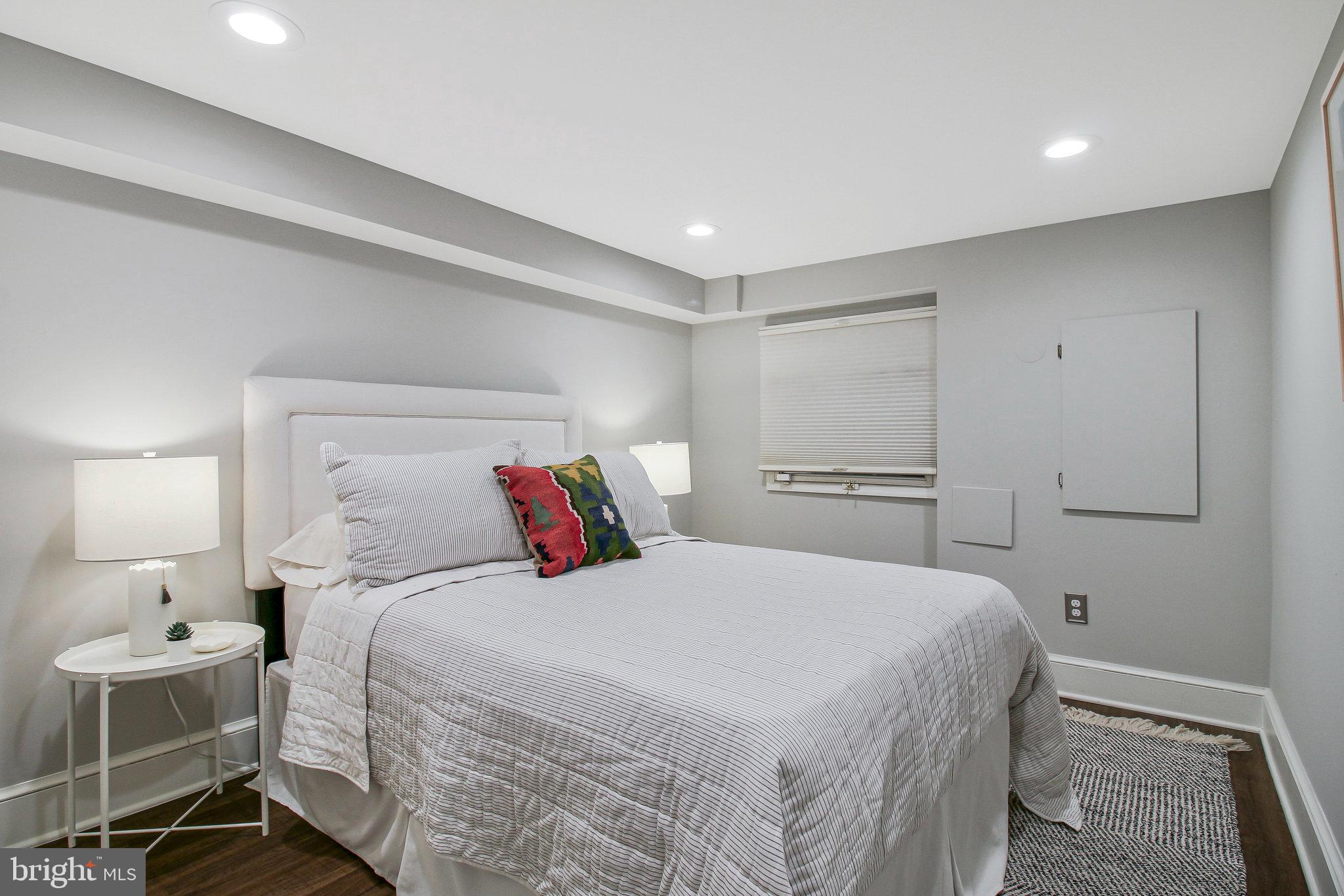 239 11th Street Southeast Washington, DC 20003 - Photo 45 of 53 a bedroom with a bed and a lamp