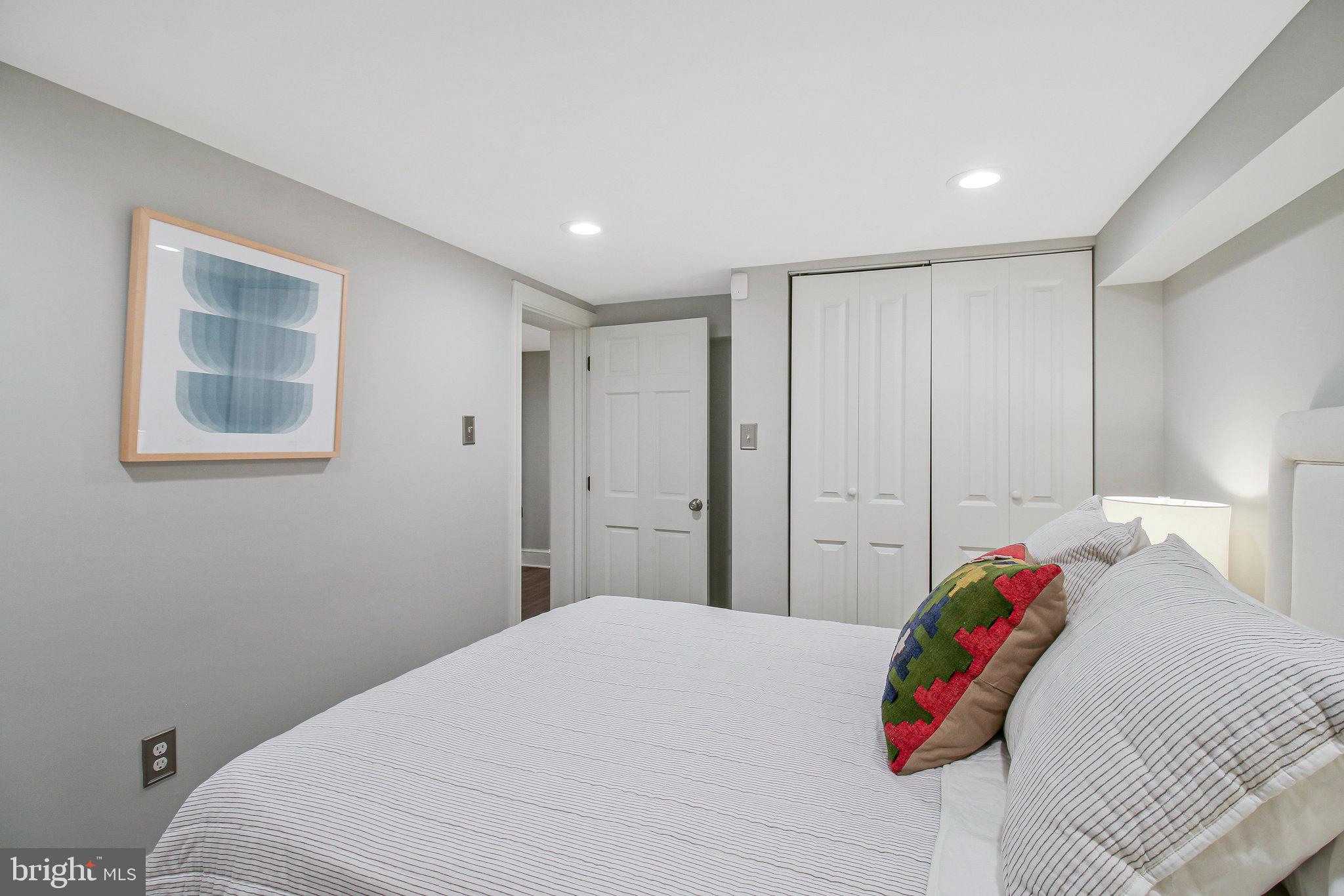 239 11th Street Southeast Washington, DC 20003 - Photo 46 of 53 a bedroom with a bed and a window