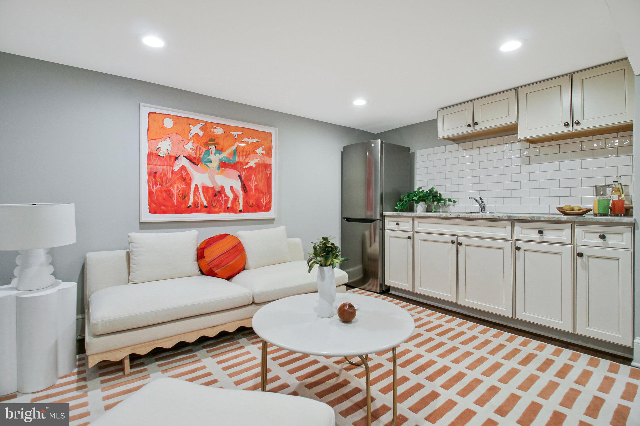 239 11th Street Southeast Washington, DC 20003 - Photo 50 of 53 a living room with furniture a rug and white walls