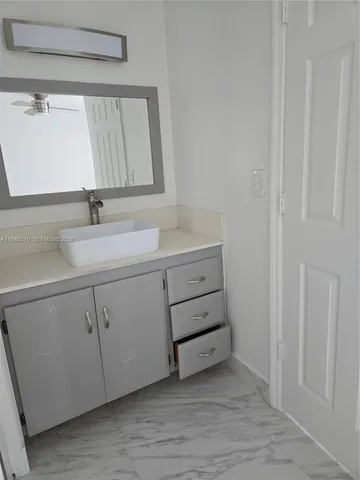 a bathroom with a toilet a sink and shower