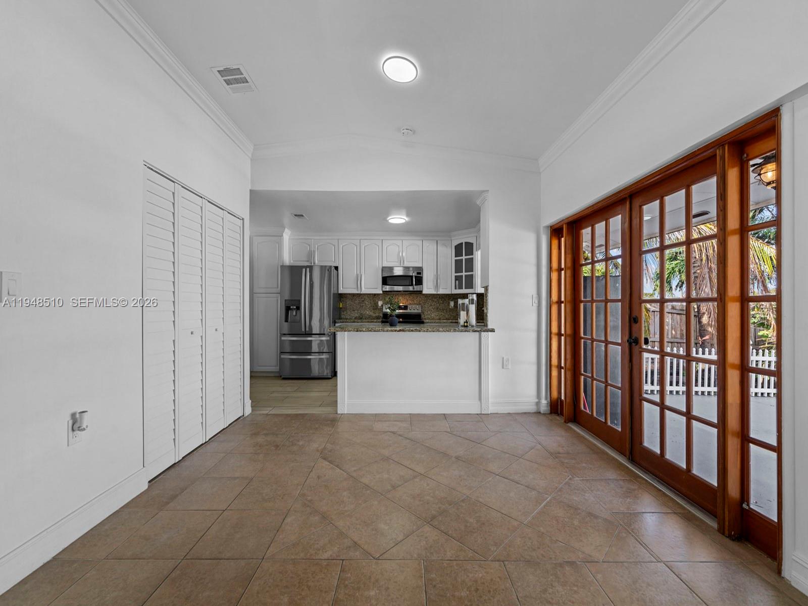 25921 Southwest 130th Avenue Homestead, FL 33032 - Photo 14 of 38 a large white kitchen with stainless steel appliances granite countertop a refrigerator and a stove top oven