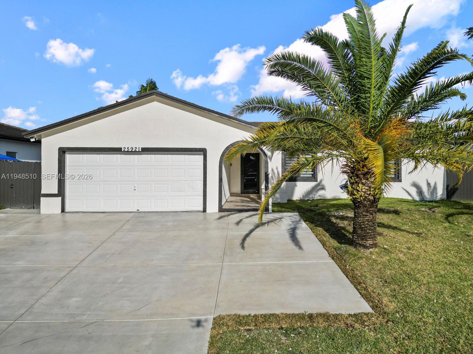 25921 Southwest 130th Avenue Homestead, FL 33032 - Photo 2 of 38 a view of a house with a yard